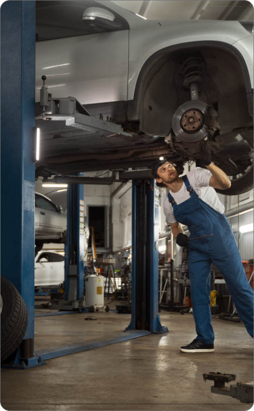 mechanic-working-car-suspension-repair-shop